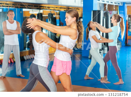 Girl using painful technique for eyes of female opponent during self-defense training 131218754