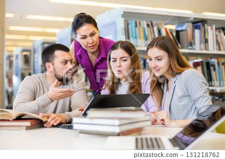 Female and male colleagues working together in public library Female and male colleagues working together in public library 131218762