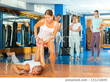 Young woman practicing self defence techniques with coach Young woman practicing self defence techniques with coach 131218845