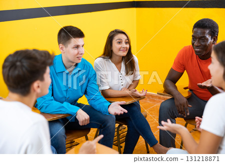 Adult university students brainstorming while preparing for exam together 131218871