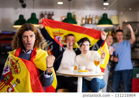 Joyful fans of the Spain team celebrating the victory in night bar Joyful fans of the Spain team celebrating the victory in night bar 131218904