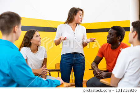 Group of multiracial people talking in speaking club Group of multiracial people talking in speaking club 131218920