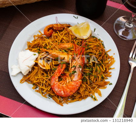 Fideua with seafood served on platter 131218940