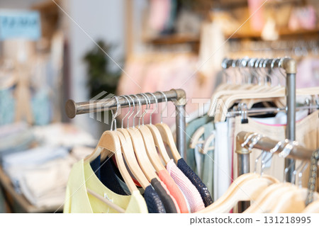 Women's clothes hanging on rack in store 131218995