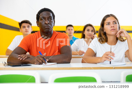 African American man and woman take a written exam in classroom 131218999