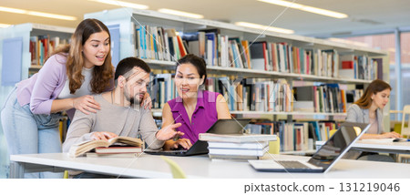 Group of students learning together at library 131219046