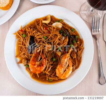 Pasta with seafood contains tiger prawns, shell mussels, spices and white sauce Pasta with seafood contains tiger prawns, shell mussels, spices and white sauce 131219097