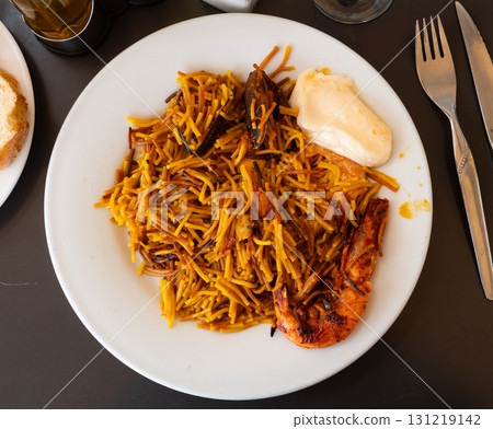 Fideua with seafood served on platter 131219142