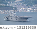 The Maritime Self-Defense Force's escort ship Kaga sails through Kure Bay with a helicopter on deck. 131219339