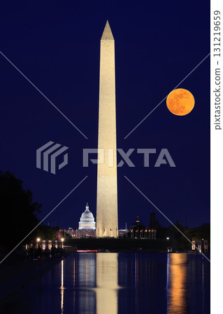 Washington DC skyline illuminated at dusk with Washington Monument and US Capitol, including a beautiful full orange moon on the background and reflections on the water, USA Washington DC skyline illuminated at dusk with Washington Monument and US Capitol, including a beautiful full orange moon on the background and reflections on the water, USA 131219659