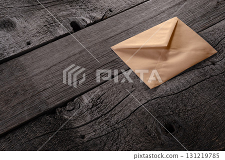 Closed Brown craft Envelope on Wooden Background Showing Texture and Simplicity. File with Clipping Path Closed Brown craft Envelope on Wooden Background Showing Texture and Simplicity. File with Clipping Path 131219785