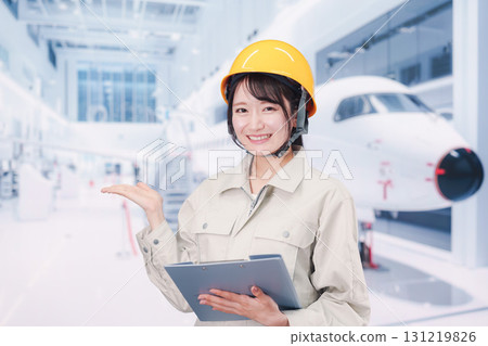 A female worker performing maintenance and inspection of an airplane 131219826
