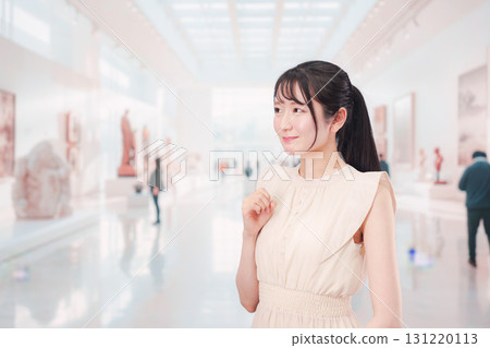 Young woman spending her holiday at an art museum or museum Young woman spending her holiday at an art museum or museum 131220113