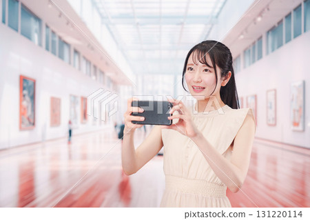 Young woman spending her holiday at an art museum or museum 131220114