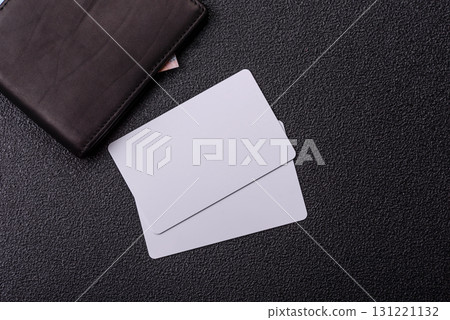 The white plastic card as a symbol of cashless payments on the background of cash paper money of Brazil 131221132