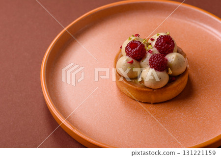 Sweet cake or tart round with cream and raspberries. Raspberry sweet tart 131221159