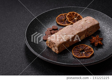 Nougat or white caramel with hazelnuts and pistachios and citrus pieces. White nougat with nuts 131221225