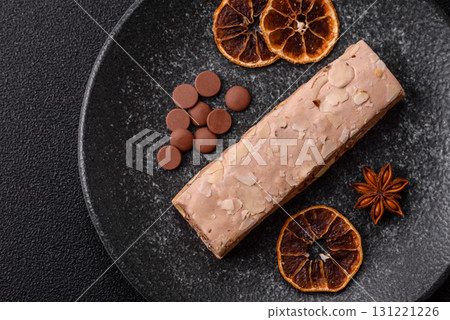 Nougat or white caramel with hazelnuts and pistachios and citrus pieces. White nougat with nuts 131221226