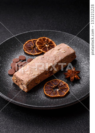 Nougat or white caramel with hazelnuts and pistachios and citrus pieces. White nougat with nuts 131221228