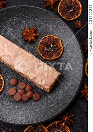 Nougat or white caramel with hazelnuts and pistachios and citrus pieces. White nougat with nuts 131221231