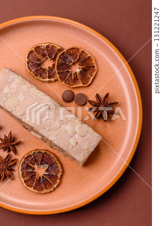 Nougat or white caramel with hazelnuts and pistachios and citrus pieces. White nougat with nuts Nougat or white caramel with hazelnuts and pistachios and citrus pieces. White nougat with nuts 131221247