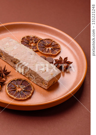 Nougat or white caramel with hazelnuts and pistachios and citrus pieces. White nougat with nuts Nougat or white caramel with hazelnuts and pistachios and citrus pieces. White nougat with nuts 131221248