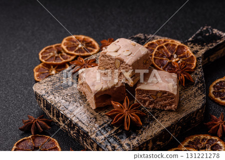 Nougat or white caramel with hazelnuts and pistachios and citrus pieces. White nougat with nuts Nougat or white caramel with hazelnuts and pistachios and citrus pieces. White nougat with nuts 131221278