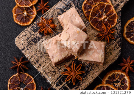 Nougat or white caramel with hazelnuts and pistachios and citrus pieces. White nougat with nuts 131221279