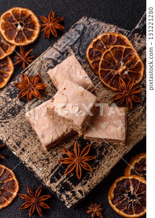 Nougat or white caramel with hazelnuts and pistachios and citrus pieces. White nougat with nuts Nougat or white caramel with hazelnuts and pistachios and citrus pieces. White nougat with nuts 131221280