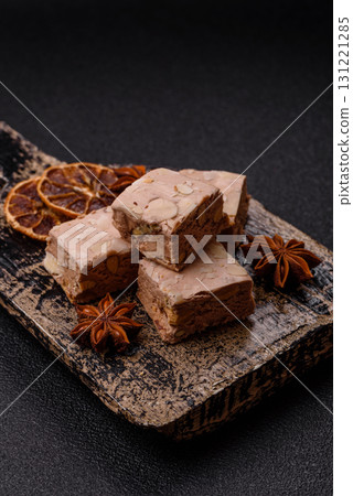 Nougat or white caramel with hazelnuts and pistachios and citrus pieces. White nougat with nuts Nougat or white caramel with hazelnuts and pistachios and citrus pieces. White nougat with nuts 131221285