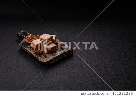 Nougat or white caramel with hazelnuts and pistachios and citrus pieces. White nougat with nuts Nougat or white caramel with hazelnuts and pistachios and citrus pieces. White nougat with nuts 131221286