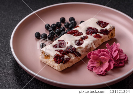 Nougat or white caramel with hazelnuts and pistachios and citrus pieces. White nougat with nuts Nougat or white caramel with hazelnuts and pistachios and citrus pieces. White nougat with nuts 131221294