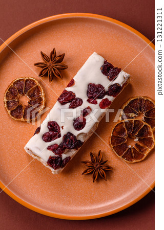 Nougat or white caramel with hazelnuts and pistachios and citrus pieces. White nougat with nuts 131221311