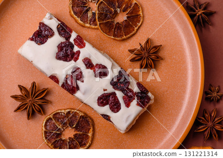 Nougat or white caramel with hazelnuts and pistachios and citrus pieces. White nougat with nuts 131221314