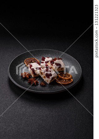 Nougat or white caramel with hazelnuts and pistachios and citrus pieces. White nougat with nuts 131221323