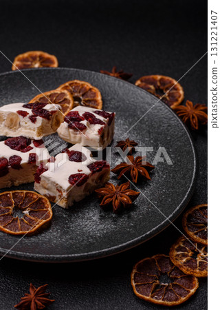 Nougat or white caramel with hazelnuts and pistachios and citrus pieces. White nougat with nuts Nougat or white caramel with hazelnuts and pistachios and citrus pieces. White nougat with nuts 131221407