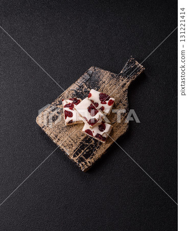 Nougat or white caramel with hazelnuts and pistachios and citrus pieces. White nougat with nuts 131221414