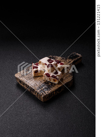 Nougat or white caramel with hazelnuts and pistachios and citrus pieces. White nougat with nuts 131221415