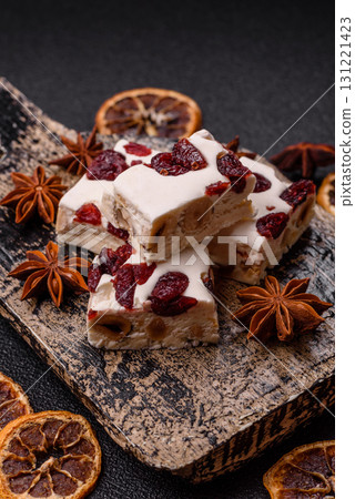 Nougat or white caramel with hazelnuts and pistachios and citrus pieces. White nougat with nuts 131221423