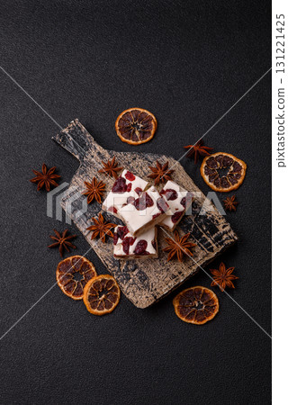 Nougat or white caramel with hazelnuts and pistachios and citrus pieces. White nougat with nuts Nougat or white caramel with hazelnuts and pistachios and citrus pieces. White nougat with nuts 131221425