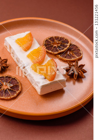 Nougat or white caramel with hazelnuts and pistachios and citrus pieces. White nougat with nuts Nougat or white caramel with hazelnuts and pistachios and citrus pieces. White nougat with nuts 131221456