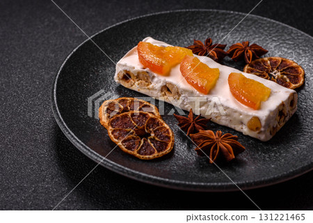 Nougat or white caramel with hazelnuts and pistachios and citrus pieces. White nougat with nuts Nougat or white caramel with hazelnuts and pistachios and citrus pieces. White nougat with nuts 131221465