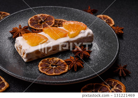 Nougat or white caramel with hazelnuts and pistachios and citrus pieces. White nougat with nuts Nougat or white caramel with hazelnuts and pistachios and citrus pieces. White nougat with nuts 131221469