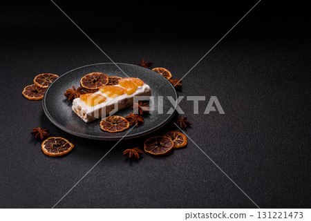 Nougat or white caramel with hazelnuts and pistachios and citrus pieces. White nougat with nuts 131221473