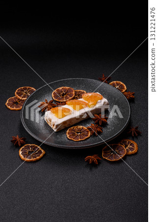 Nougat or white caramel with hazelnuts and pistachios and citrus pieces. White nougat with nuts Nougat or white caramel with hazelnuts and pistachios and citrus pieces. White nougat with nuts 131221476