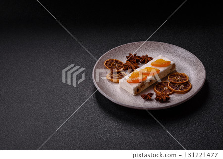 Nougat or white caramel with hazelnuts and pistachios and citrus pieces. White nougat with nuts Nougat or white caramel with hazelnuts and pistachios and citrus pieces. White nougat with nuts 131221477