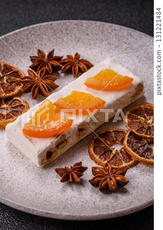 Nougat or white caramel with hazelnuts and pistachios and citrus pieces. White nougat with nuts Nougat or white caramel with hazelnuts and pistachios and citrus pieces. White nougat with nuts 131221484
