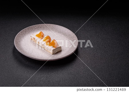 Nougat or white caramel with hazelnuts and pistachios and citrus pieces. White nougat with nuts 131221489