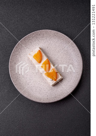 Nougat or white caramel with hazelnuts and pistachios and citrus pieces. White nougat with nuts Nougat or white caramel with hazelnuts and pistachios and citrus pieces. White nougat with nuts 131221491