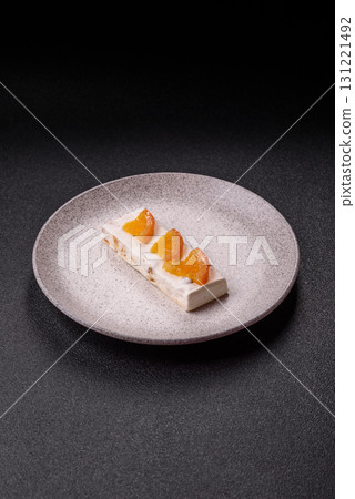 Nougat or white caramel with hazelnuts and pistachios and citrus pieces. White nougat with nuts Nougat or white caramel with hazelnuts and pistachios and citrus pieces. White nougat with nuts 131221492